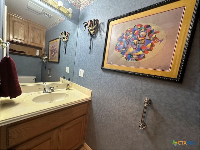 bathroom featuring vanity and toilet