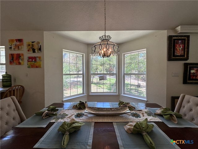 dining area with a chandelier and plenty of natural light