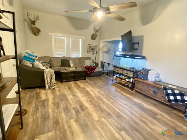 living room featuring hardwood / wood-style floors and ceiling fan