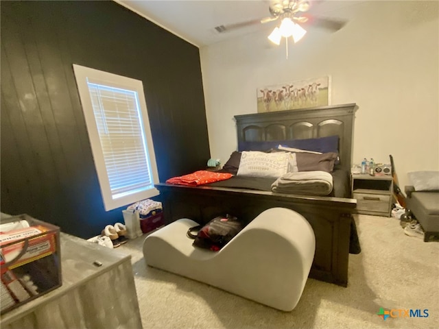 bedroom featuring ceiling fan and light carpet