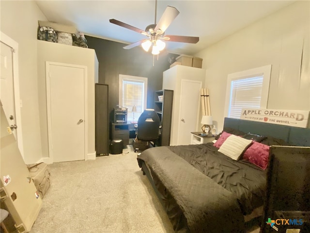 bedroom featuring light colored carpet and ceiling fan