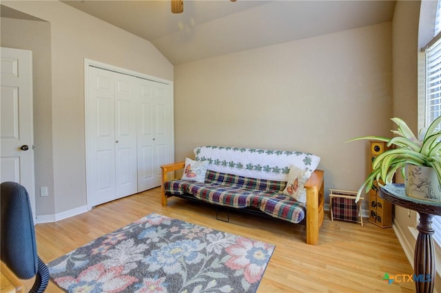 sitting room featuring lofted ceiling, baseboards, a ceiling fan, and wood finished floors