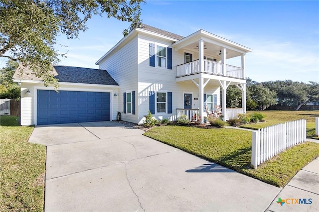 view of front facade featuring a balcony, ceiling fan, a garage, and fence