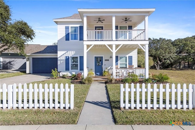 view of front of house featuring a fenced front yard, covered porch, concrete driveway, a ceiling fan, and a balcony