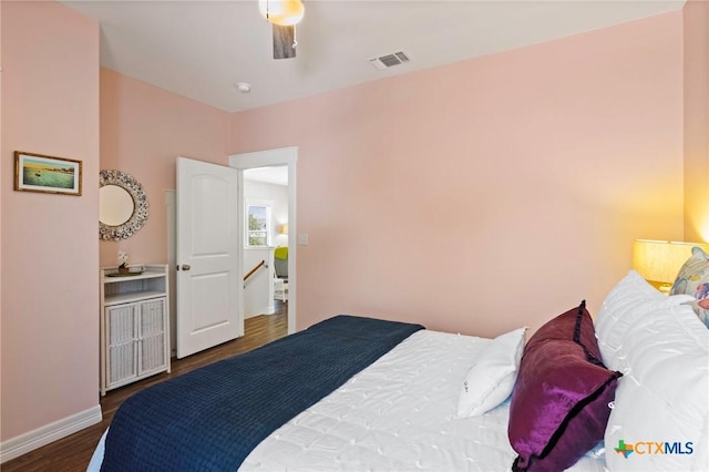 bedroom with baseboards, visible vents, ceiling fan, and wood finished floors