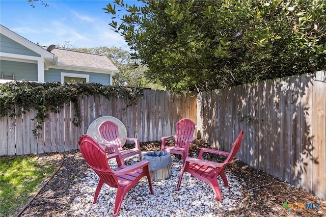 view of patio / terrace featuring a fenced backyard and a fire pit