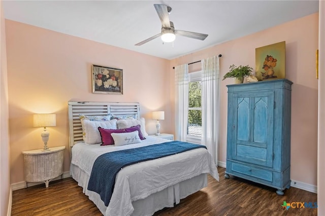 bedroom featuring ceiling fan, baseboards, and wood finished floors