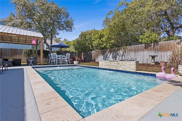 view of swimming pool with a fenced backyard, a fenced in pool, and a patio