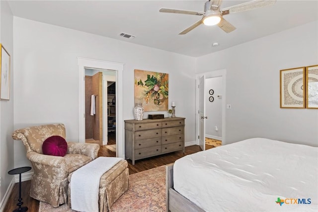 bedroom with ceiling fan, wood finished floors, visible vents, and baseboards