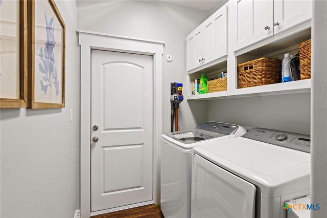 clothes washing area with cabinet space and separate washer and dryer