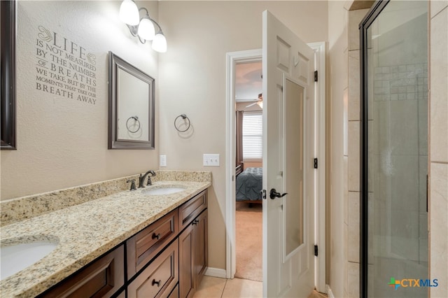 bathroom with vanity, an enclosed shower, and tile patterned floors