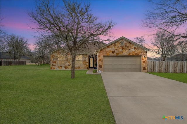 view of front of house with a garage and a lawn