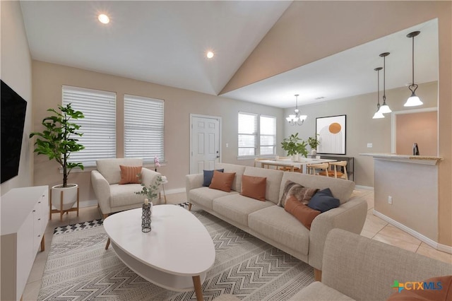 living room with a notable chandelier, vaulted ceiling, and light tile patterned flooring