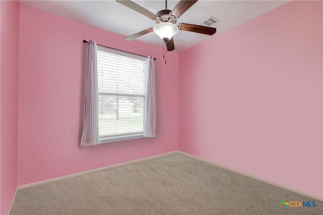 empty room featuring ceiling fan and carpet floors