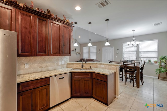 kitchen featuring light tile patterned flooring, appliances with stainless steel finishes, decorative light fixtures, and sink