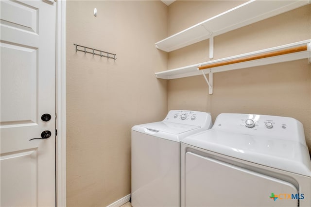 clothes washing area featuring separate washer and dryer