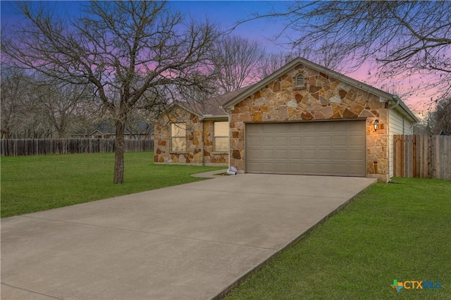 view of front facade with a garage and a lawn