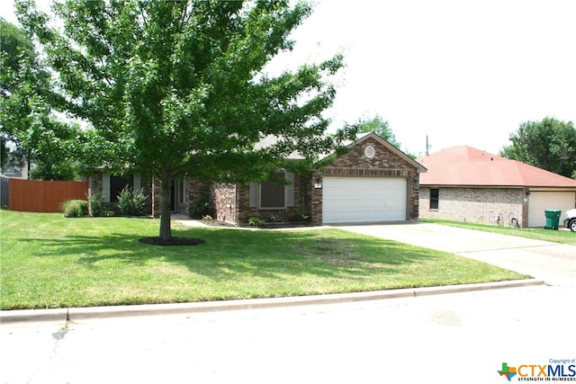 view of front of house featuring a garage and a front lawn