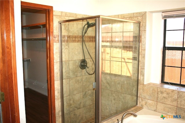 bathroom featuring separate shower and tub