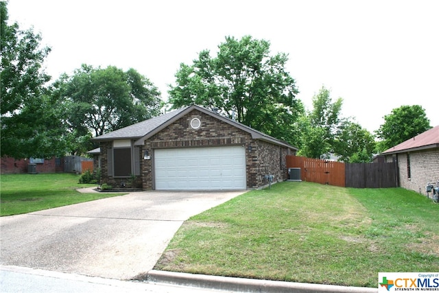 view of front facade featuring cooling unit, a garage, and a front lawn