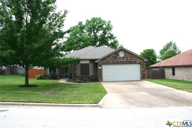 view of front of house featuring a garage and a front lawn