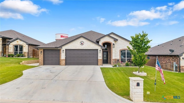 3424 Waggoner Dr, Belton, TX 76513 - french country home featuring an attached garage, driveway, a front lawn, brick siding, and stone siding