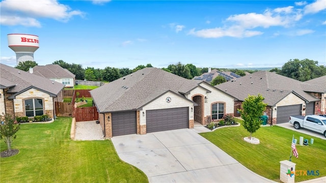 3424 Waggoner Dr, Belton, TX 76513 - french country inspired facade with a garage, brick siding, concrete driveway, roof with shingles, and stone siding
