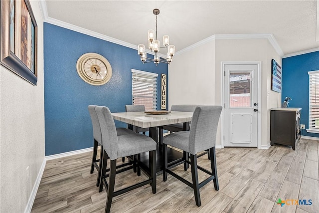 3424 Waggoner Dr, Belton, TX 76513 - dining room with a chandelier, wood finished floors, crown molding, and a textured wall