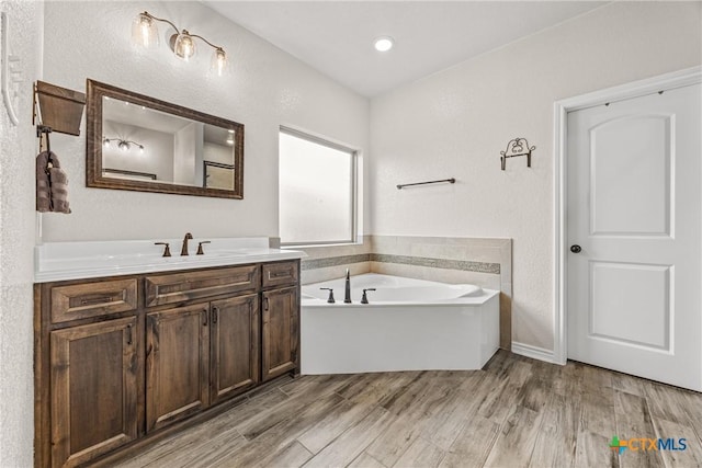 3424 Waggoner Dr, Belton, TX 76513 - full bathroom featuring vanity, a bath, and wood finished floors