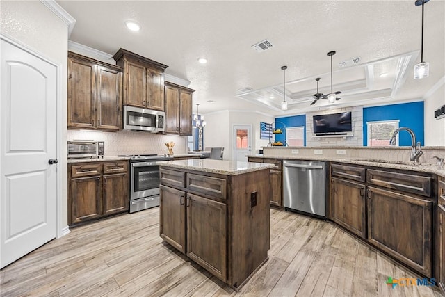 3424 Waggoner Dr, Belton, TX 76513 - kitchen with stainless steel appliances, crown molding, a ceiling fan, light wood-style floors, and decorative backsplash