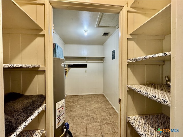 spacious closet featuring gas water heater and visible vents