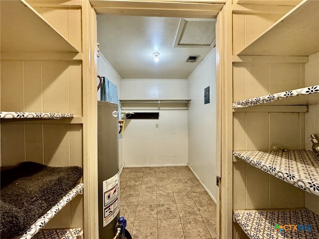 walk in closet featuring water heater and visible vents