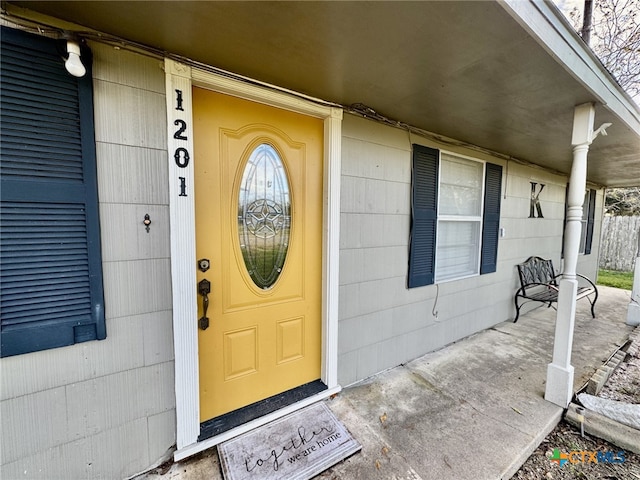 doorway to property featuring covered porch