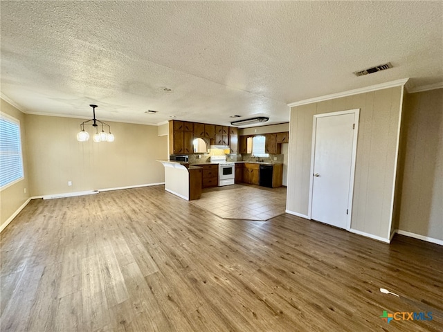 unfurnished living room with dark wood-style floors, visible vents, ornamental molding, and an inviting chandelier