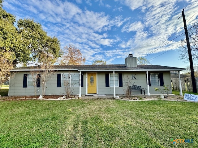 single story home with a chimney and a front lawn