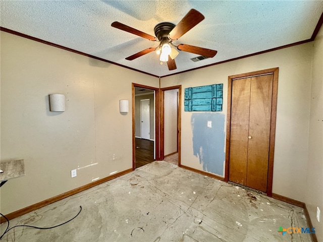 unfurnished bedroom with a textured ceiling, a ceiling fan, visible vents, baseboards, and ornamental molding