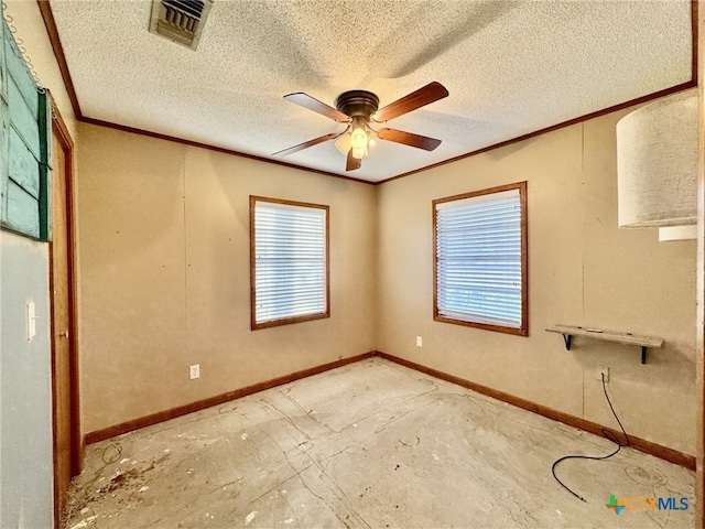 empty room with visible vents, ornamental molding, and a wealth of natural light