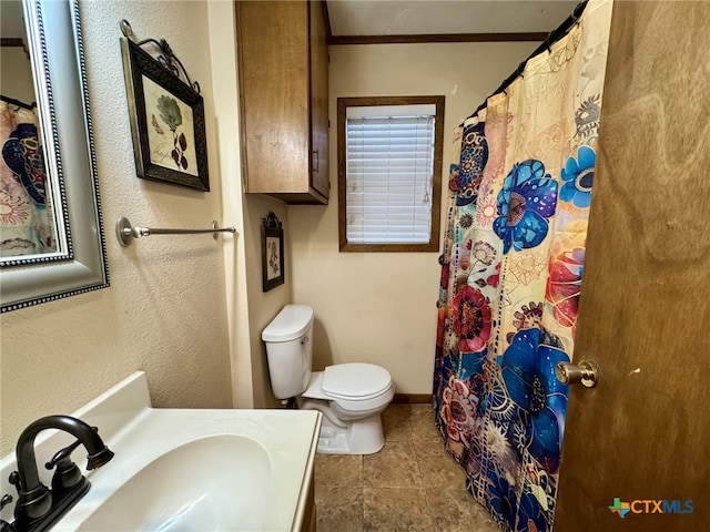 full bathroom featuring toilet, vanity, baseboards, ornamental molding, and tile patterned floors