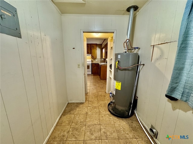 utility room featuring gas water heater and a sink