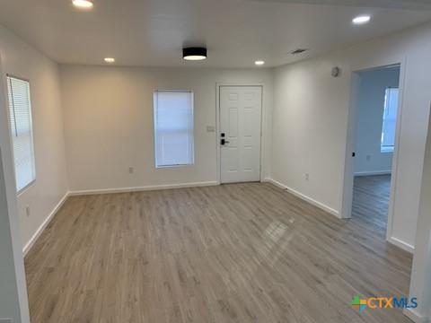 empty room featuring plenty of natural light and light wood-type flooring