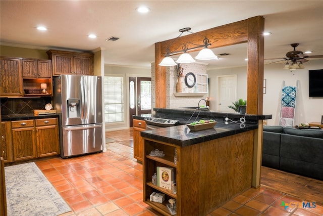 kitchen with ornamental molding, ceiling fan, backsplash, appliances with stainless steel finishes, and decorative light fixtures