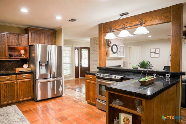 kitchen with a fireplace, crown molding, stainless steel appliances, backsplash, and decorative light fixtures