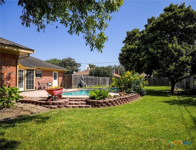 view of yard featuring a fenced in pool and a patio area