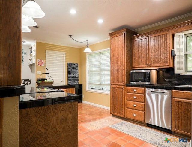 kitchen with hanging light fixtures, crown molding, a healthy amount of sunlight, and stainless steel appliances