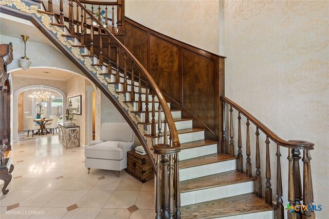 6 Carriage Sq, Waco, TX 76708 - stairway with tile patterned floors, arched walkways, an inviting chandelier, a high ceiling, and crown molding