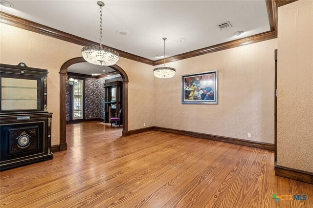 6 Carriage Sq, Waco, TX 76708 - unfurnished dining area with arched walkways, crown molding, hardwood / wood-style floors, and visible vents