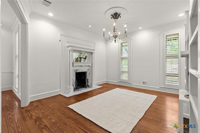 6 Carriage Sq, Waco, TX 76708 - living room with a fireplace, a chandelier, visible vents, and ornamental molding