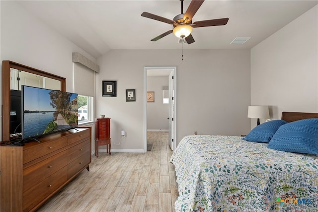 220 Bolivar Way Unit 101, San Marcos, TX 78666 - bedroom featuring light wood finished floors, baseboards, lofted ceiling, and ceiling fan