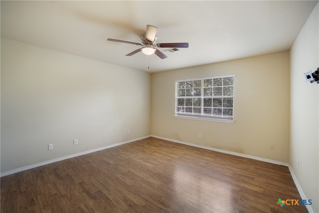 unfurnished room featuring dark hardwood / wood-style flooring and ceiling fan