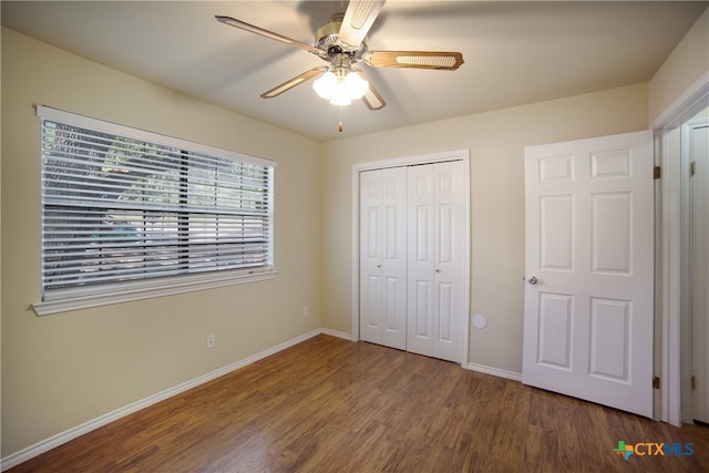 unfurnished bedroom featuring hardwood / wood-style flooring, ceiling fan, and a closet